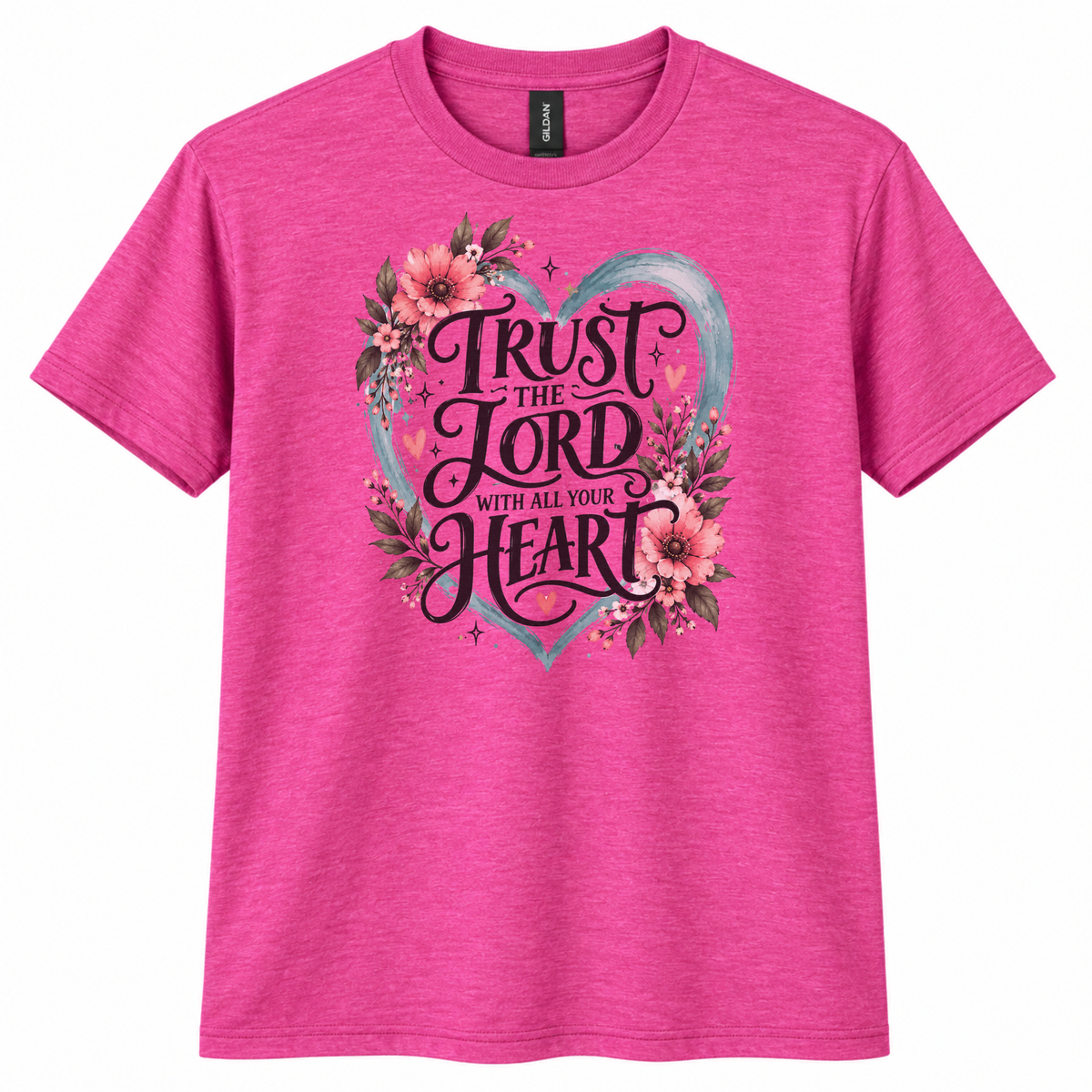 A bright pink heather crewneck t-shirt featuring a graphic design on the front. The design shows a stylized teal heart outline surrounded by pink and orange flowers with the text 'TRUST THE LORD WITH ALL YOUR HEART' in black script.