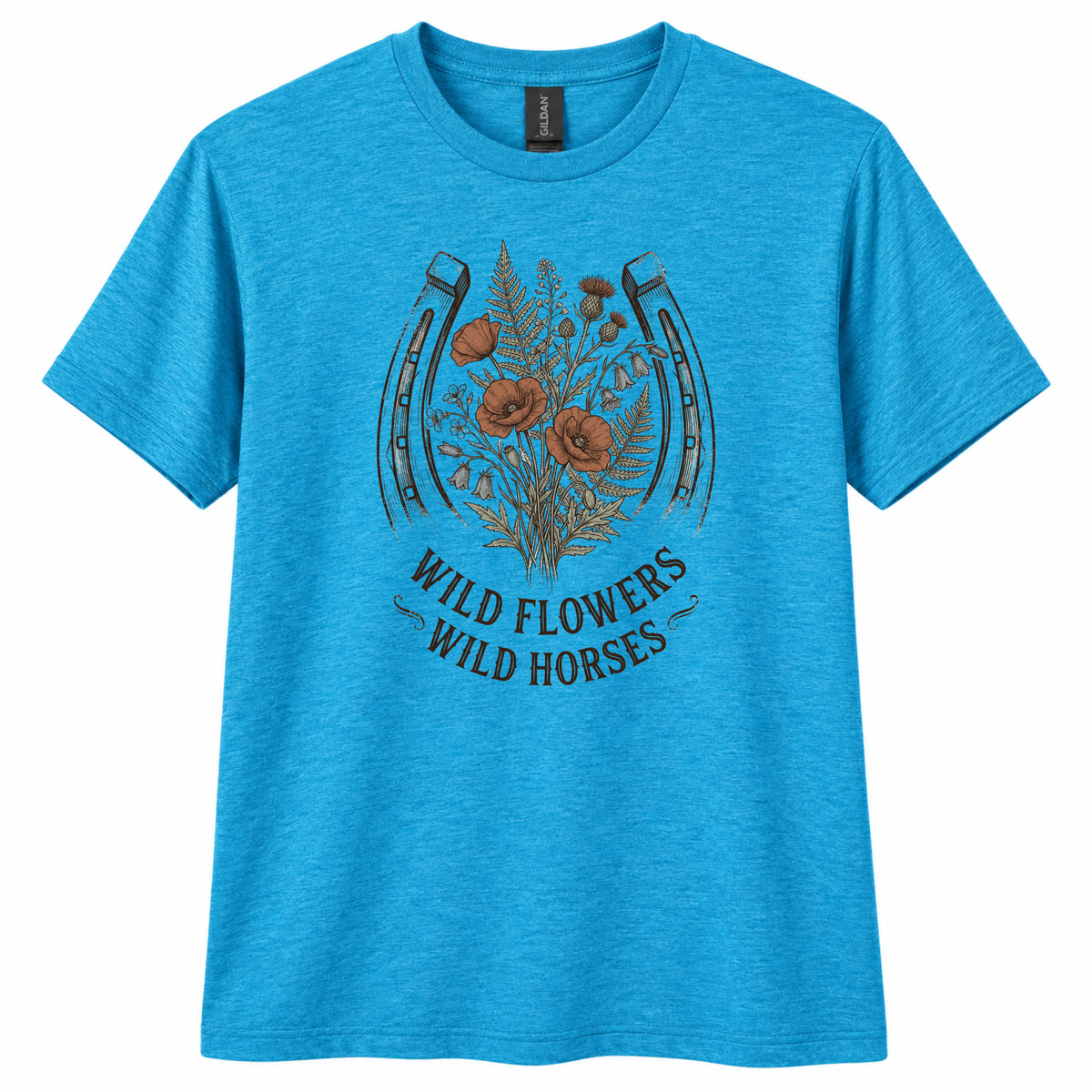 A heather blue short-sleeve crewneck t-shirt featuring a graphic of a horseshoe with wildflowers and the text 'WILD FLOWERS WILD HORSES' printed on the front.